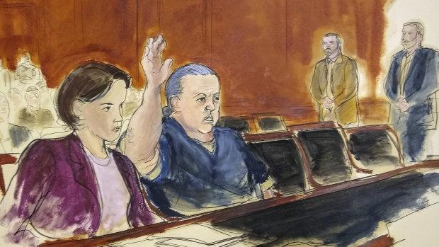 In this file courtroom sketch, Cesar Sayoc raises his arm to swear to the truth of his statement of need for assigned counsel, during his presentment in Manhattan Federal Court in New York. 