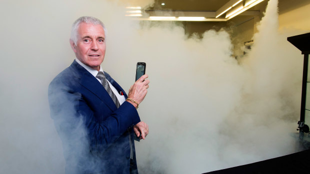 Jeweller Garry Holloway tests his smoke security system.