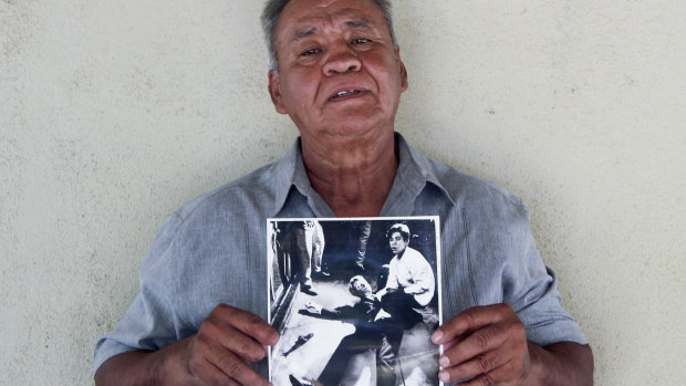 Juan Romero, 67, holds a photo of himself and the dying Senator Robert F. Kennedy at the Ambassador Hotel in Los Angeles, taken by the Los Angeles Times' Boris Yaro on at his home in Modesto, California. 