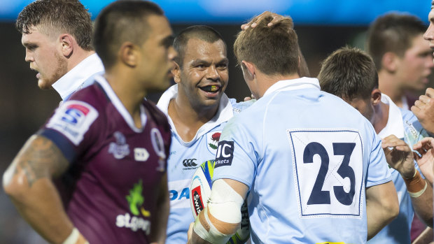 Rivalry: Kurtley Beale congratulates Alex Newsome on scoring a try against Queensland in round four. 