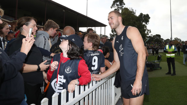 Blues star Harry McKay poses for photos with fans during a Carlton training session at Unley Oval ahead of Gather Round.