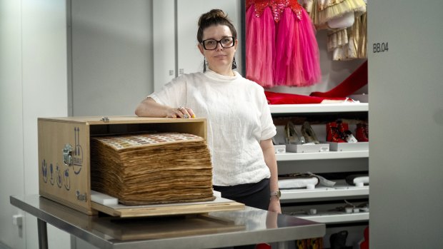 APAC curator Sandra Bruce with the 500-page scrapbook documenting the history of the circus.