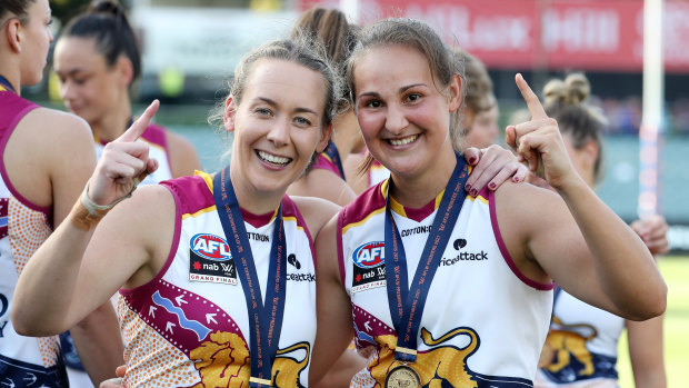Lauren Arnell (left) with premiership teammate Breanna Koenen after the 2021 grand final in Adelaide.