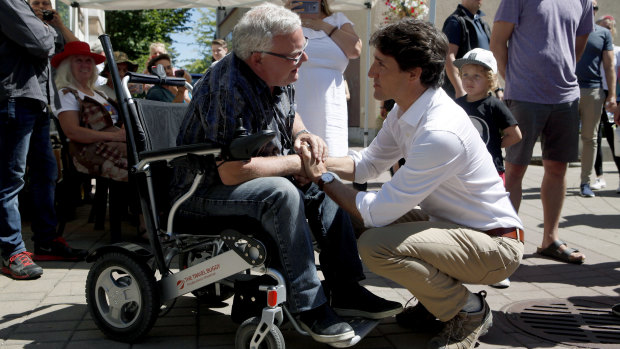 Justin Trudeau, right, meets with Duncan Mayor Phil Kent as he visits locals at the Duncan Farmers Market in Duncan, British Columbia.