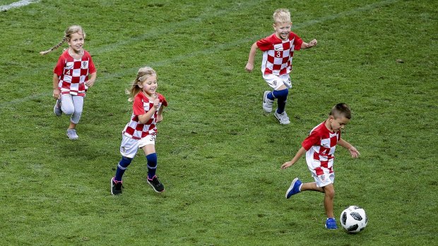 Youth development: Croatian players' children took to the field after their semi-final win.