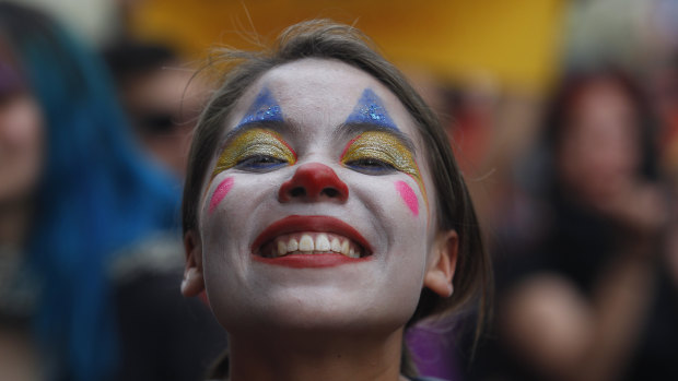 A woman made up as a clown poses during the eighth day of protests against President Sebastian Piñera's government. 
