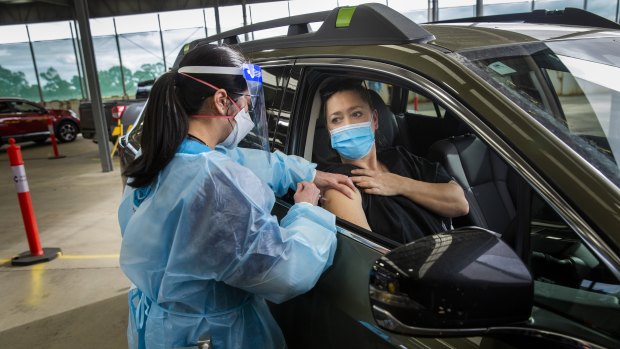Health worker Khanh Tran  gives Nicolette Kolozsi her first Pfizer jab on Sunday at the drive-through clinic, which will officially open on Monday.

