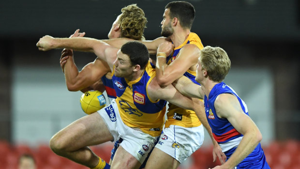 In the thick of it: Jeremy McGovern (front left) attempts a spoil during the Eagles narrow loss to the Bulldogs.