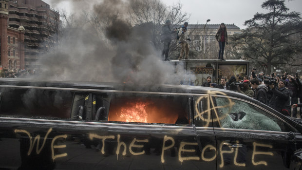 Protesters burn a limousine during the January 20 demonstrations against the inauguration of US President Donald Trump.
