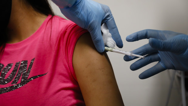 A health worker injects a person during clinical trials for a COVID-19 vaccine at Research Centres of America in Hollywood, Florida, US.
