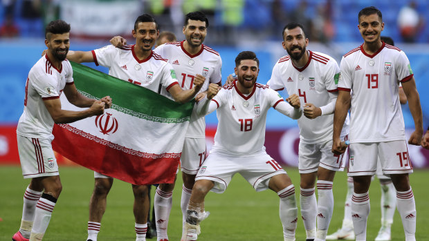 All smiles: Iran's players celebrate their victory.