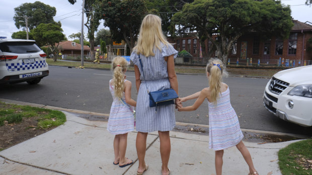 Ella with her daughters Alexia and Jasmine, who are pupils at Sandringham Primary School, look on after the school was partly destroyed in a fire overnight.