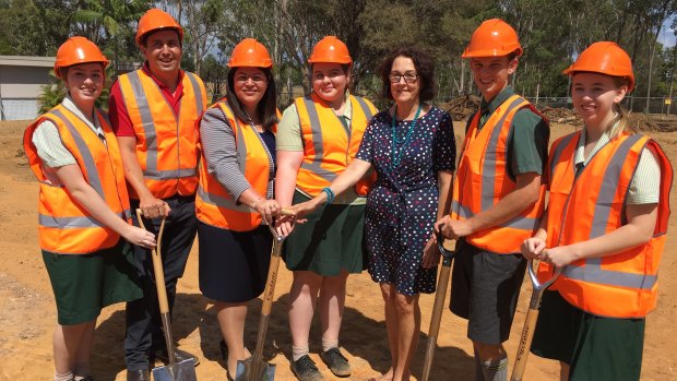 Queensland Education Minister Grace Grace with Capalaba MP Don Brown, Alexandra Hills State High School Principal Gail Armstrong and students turn the first sod at the site of the school's new automation and robotics centre.