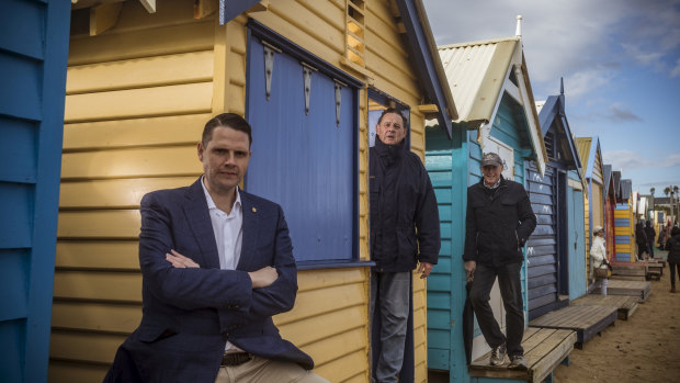 Brighton MP James Newbury with members of the Brighton Bathing Box Association, Bill Mears and Geoff Cunningham at Bill's beach box in Brighton.