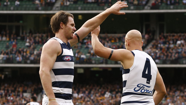 Gary Ablett celebrates a goal with Patrick Dangerfield.