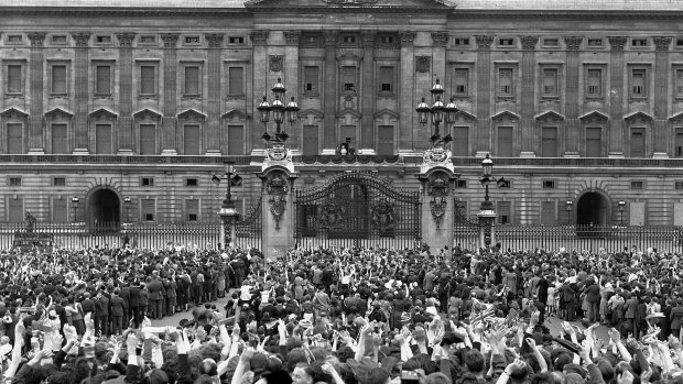 A vast crowd assembles in front of Buckingham Palace, London to cheer Britain's Royal family as they come out on the balcony, centre, minutes after the official announcement of Germany's unconditional surrender in World War II on May 8, 1945. 