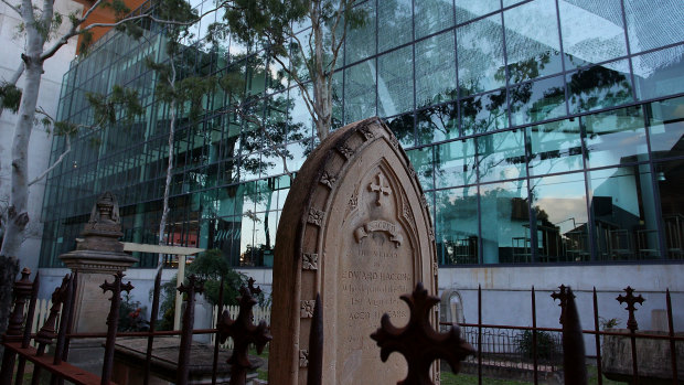 'Veil', the artwork on Suncorp Stadium near Christ Church, can be seen above the gravestones.