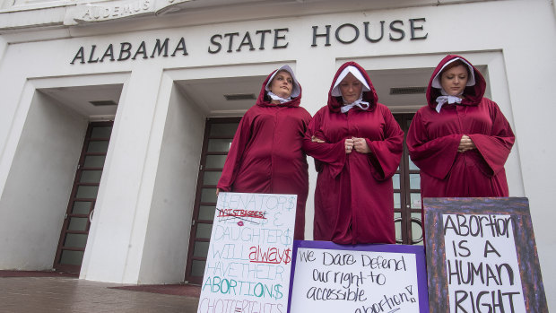 Women protest against a bill banning nearly all abortions at the Alabama State House in Montgomery, Alabama.
