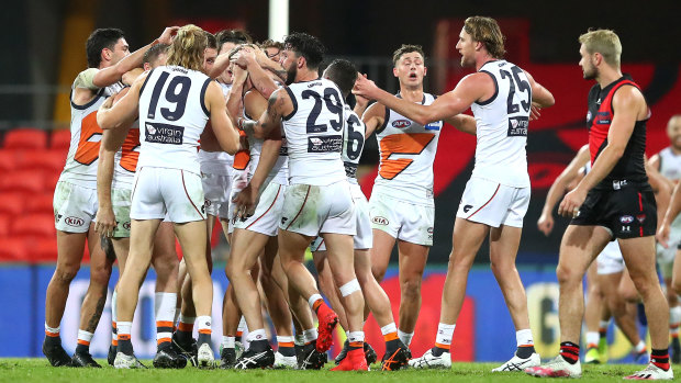 Callan Ward of the Giants is congratulated by team mates after kicking the goal that sealed the match. 