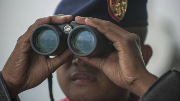 A crew member of Indonesian Navy ship KRI Ngurah Rai conducts a search for the victims of Lion Air plane crash in the waters of Tanjung Karawang, Indonesia, in October.