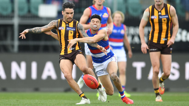 Chad Wingard tackled by Jason Johannisen.