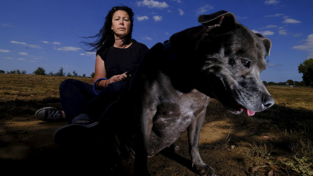 Lianne, seen here with her dog in Wyndham Vale, is taking Melbourne Uni to court over gender discrimination.