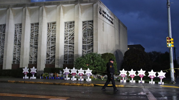 A Pittsburgh Police officer walks past the Tree of Life Synagogue.