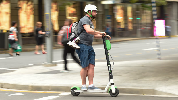 A Lime scooter user on the streets of Brisbane.