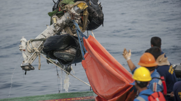 Rescuers using a crane to retrieve part of the landing gears of the crashed Lion Air jet from the sea floor in the waters of Tanjung Karawang, Indonesia.