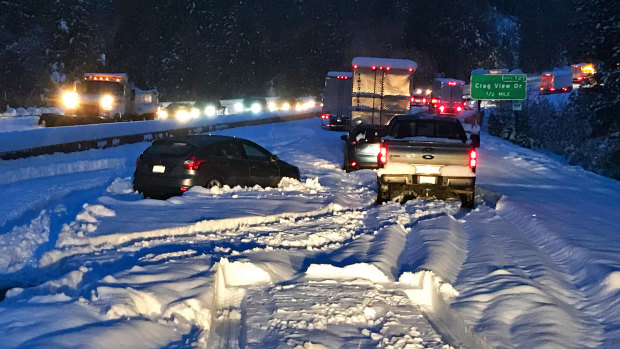 Cars and trucks in stopped traffic on Interstate 5 near Dunsmuir, California, after a "bomb cyclone" cause temperatures to drop suddenly.