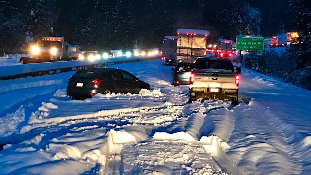 Cars and trucks in stopped traffic on Interstate 5 near Dunsmuir, California, after a "bomb cyclone" cause temperatures to drop suddenly.