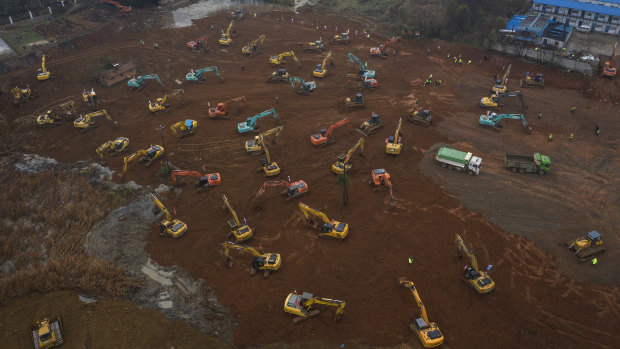 Workers driving excavators at the construction site of a field hospital in Wuhan, China, which was ordered to be built in 10 days to deal with the outbreak.