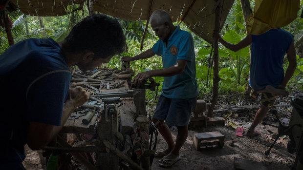 A gunsmith crafts a .45-calibre pistol by hand in a hut in the woods near Danao, Philippines. An estimated two million unregistered guns are owned in the country, more than the number of registered weapons. 