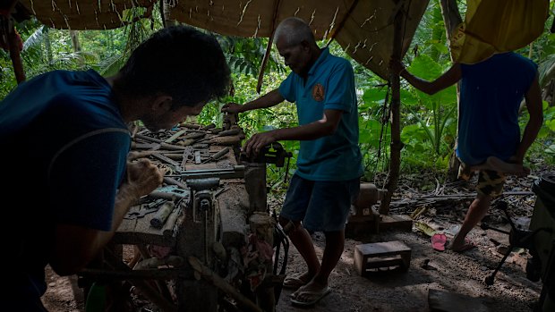 A gunsmith crafts a .45-calibre pistol by hand in a hut in the woods near Danao, Philippines. An estimated two million unregistered guns are owned in the country, more than the number of registered weapons. 