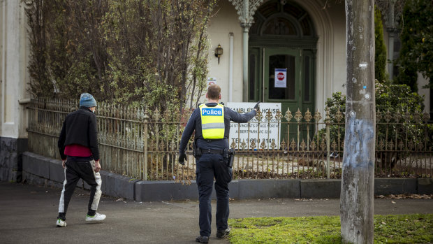Police escort a resident of Hambleton House back to his residence after he left the property on Monday morning. Hambleton House is currently under lockdown after a COVID-19 outbreak. 