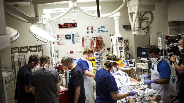 A man brought into the ED under cardiac arrest is worked on by the emergency team in the busy emergency department of the Royal Melbourne Hospital.