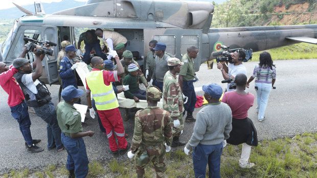The injured survivors in Chimanimani, Zimbabwe, are escorted into helicopters.
