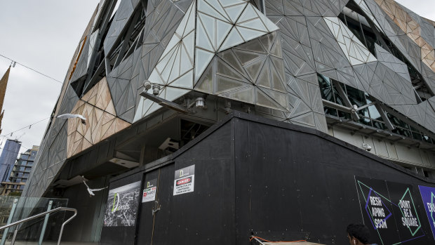 The front of ACMI at Federation Square is boarded up during renovation.