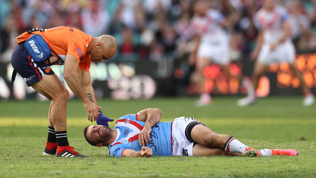 James Tedesco receives assistance after being floored by Jordan Pereira.