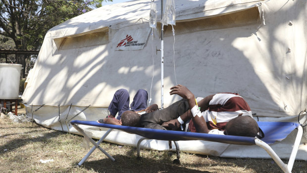 Patients rest at a field hospital in Harare. A cholera emergency has been declared in Zimbabwe's capital after 20 people died.
