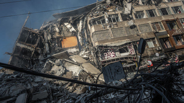 Smoke rises from the rubble of Al-Shorouk Tower following an Israeli airstrike in Gaza City.