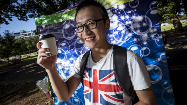 Ming from Shanghai gets ready for the fireworks in Yarra Park with a Melbourne coffee.