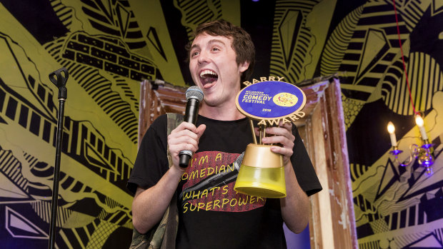 Comic Sam Campbell holds up his Barry Award.