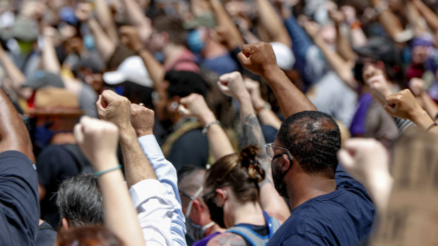 Demonstrators raise fists in the air during a march in Pittsburgh to protest the death of George Floyd.