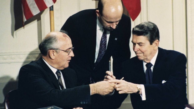 US President Ronald Reagan, right, and Soviet leader Mikhail Gorbachev exchange pens during the Intermediate Range Nuclear Forces Treaty signing ceremony in the White House in 1987. 