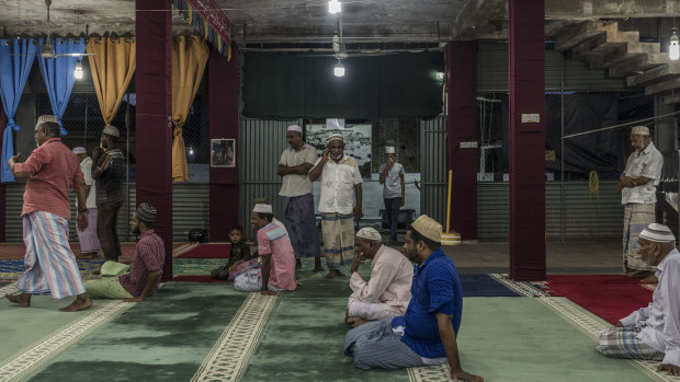Men pray in the Badhiriy Yah Jumah Mosque. in Kattankudy, Sri Lanka.