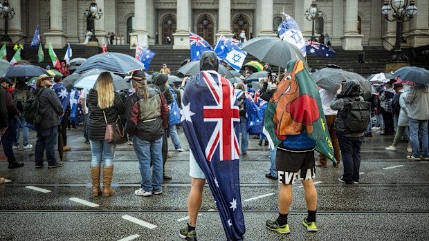 Protesters converge outside Parliament House in Melbourne.