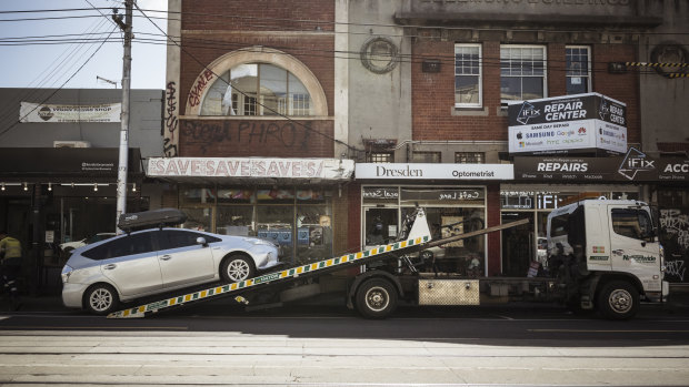 A car being towed from a clearway zone on Sydney Road in Brunswick.