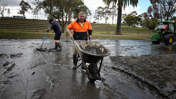 Peter Whelan cleaning the front of his house after the floods next to the Maribyrnong river on Sunday.