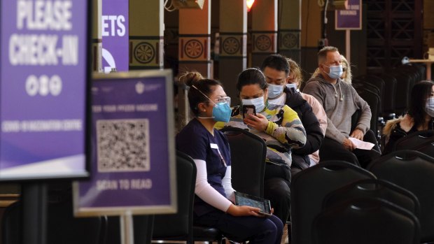 Patients wait for a COVID-19 jab at Melbourne’s Royal Exhibition Building. 